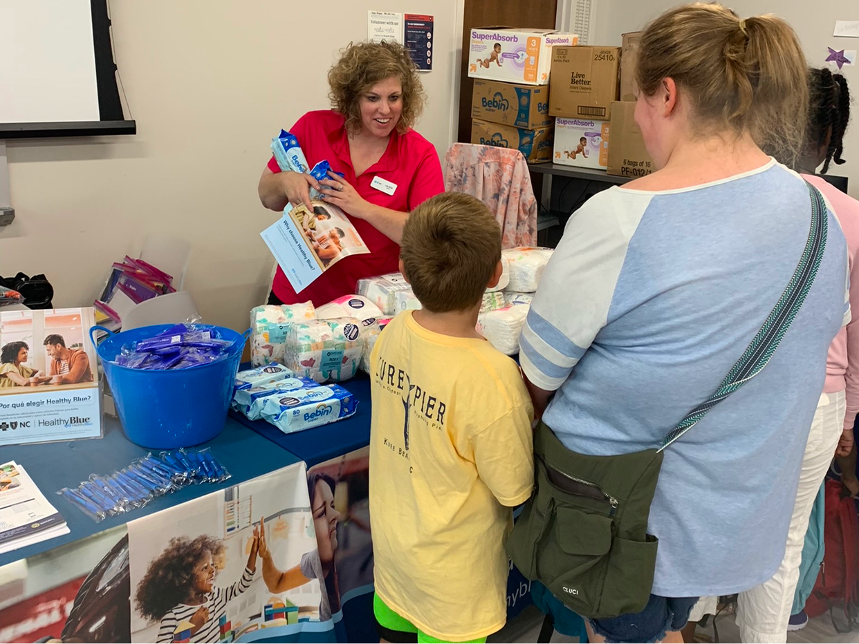 Participants at table attending a distribution event.