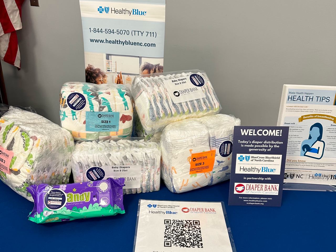 Diapers, wipes, and resources on a table for families in need.